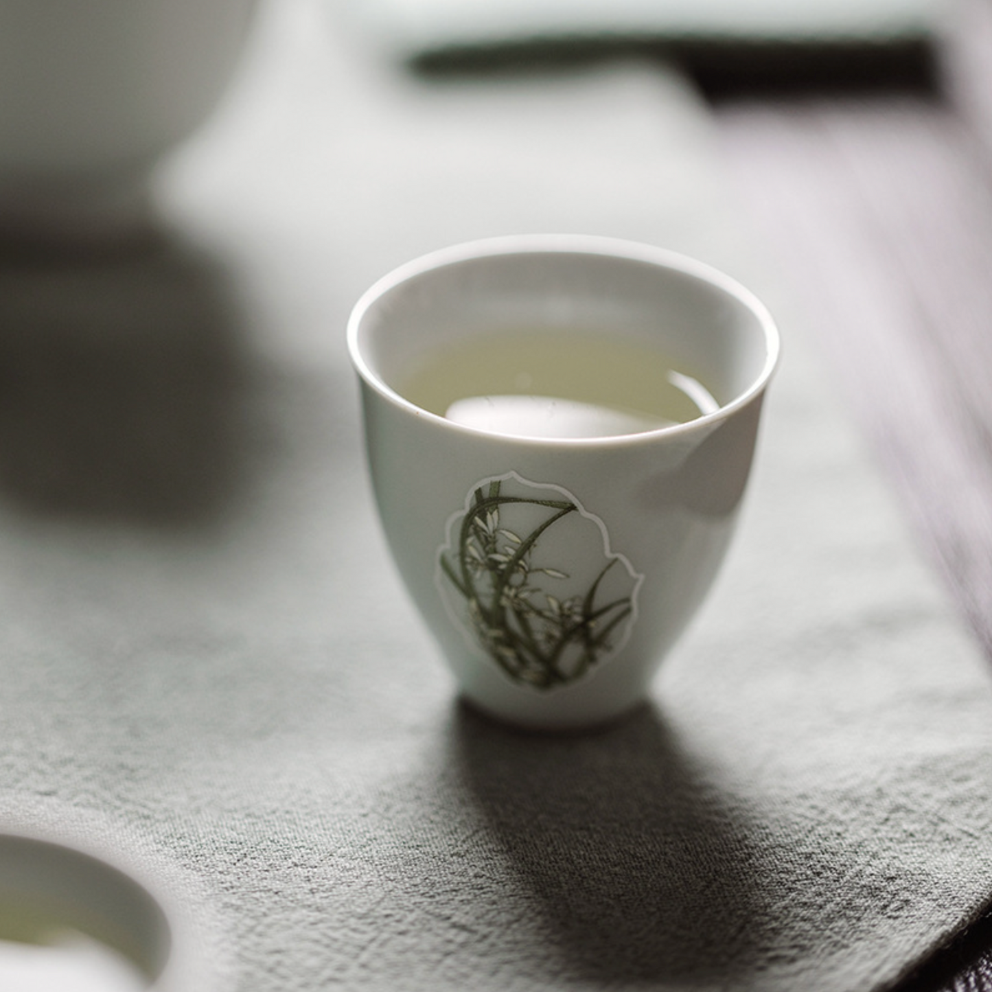 Gu Qing Porcelain Window Orchid Tea Cup